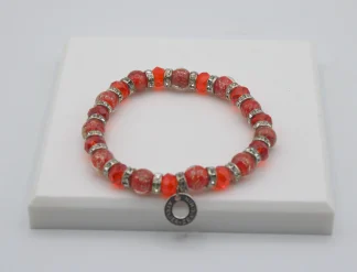 Red Murano glass bead stretch bracelet with bling and a charm