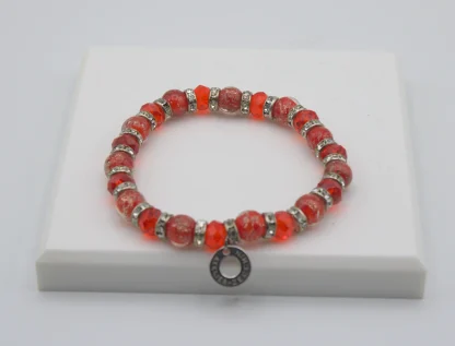 Red Murano glass bead stretch bracelet with bling and a charm