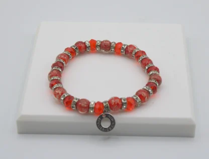 Red Murano glass bead stretch bracelet with bling and a charm