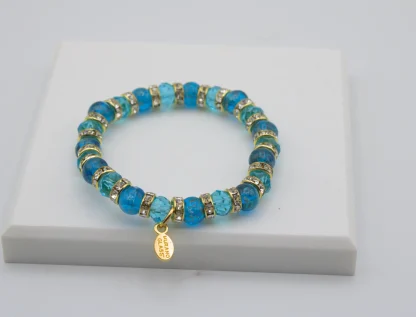 Turquoise Murano glass bead stretch bracelet with bling and a charm
