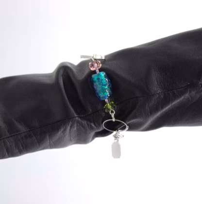 multi-color chrome bracelet shown on black glove