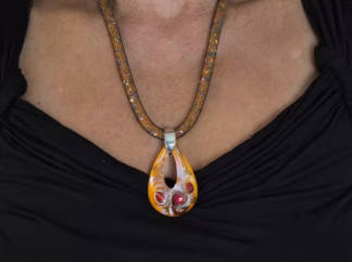 Murano glass necklace with 2 inch long 1 inch wide lampworked orange and red teardrop pendant on 18 inch mesh cord filled with sparkling seed beads