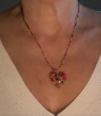 Murano glass heart necklace gold and copper on bed of red glass, heart is 1 inch wide by 1 inch long on a 16 inch long gold and red Italian seed bead cord