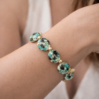 Murano bracelet aqua color on cream color beads stretch bracelet with gold details on wrist