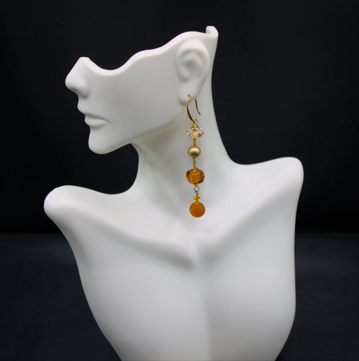 Murano long drop amber tone earrings. Four different types of Murano glass on a three inch drop with additional small glass detail in between them.