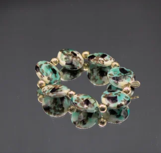 Murano bracelet aqua color on cream color beads stretch bracelet with gold details.