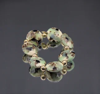 Murano stretch bracelet circular lampworked oss green and brown on cream Murano glass wit gold details