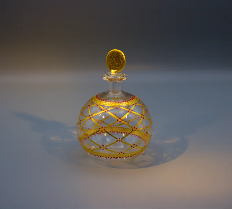 Murano blown glass delicate round scent or perfume bottle with gold lattice design, dotted with red.