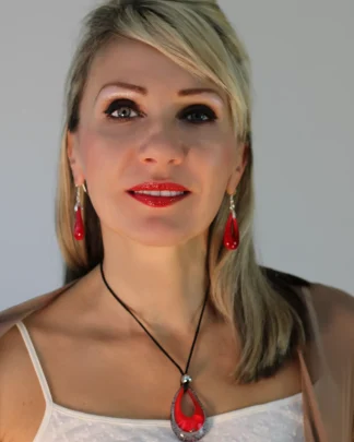 Deep red Murano glass teardrop pendant 2 1/2 inches long 1 1/2 inches wide with black and silver edging on a 16 inch cotton cord