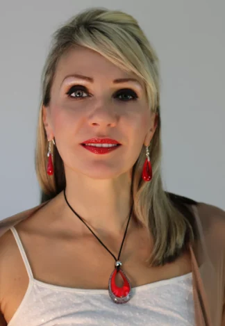 Deep red Murano glass teardrop pendant 2 1/2 inches long 1 1/2 inches wide with black and silver edging on a 16 inch cotton cord