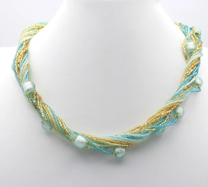 Sparkling gold and turquoise seed beads on 16 separate strands twist create a stunning look with turquoise round Murano beads interspersed