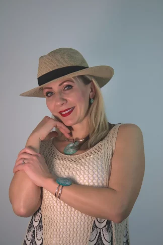 model wearing green with silver highlights Murano glass large disc pendant, bracelet and matching earrings